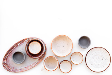 Ceramic tableware pattern. Empty plates and mugs on white background top view copy space