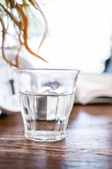 Glass of water on wooden table with copy space.