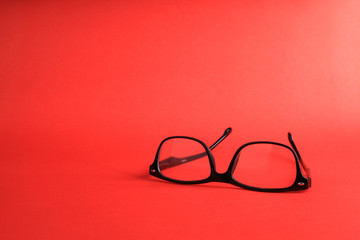 Glasses on red background