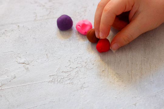 Child Hand Holding Ball Of Modelling Clay With Three Fingers. Three Fingers Grip. Side View With Copy Space. Child Psychology, Neuropsychology Fine Motor Skills Manual Dexterity Mental Health