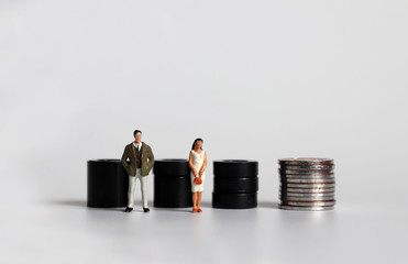 Equal labor equal pay concept. Miniature woman with a miniature man. 