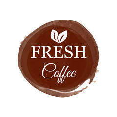 Creative logo in form of big brown stain with fresh coffee decorated coca tree leaves