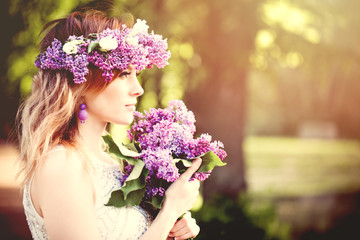 Naklejka premium Beautiful woman face outdoors portrait. Girl with spring flowers, profile