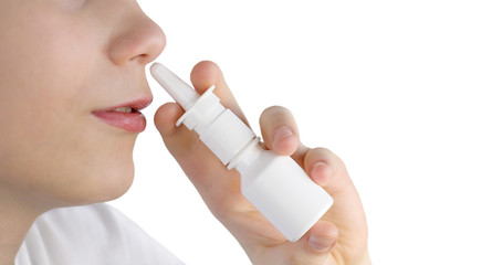 Teenager using nasal spray close-up isolated on a white background