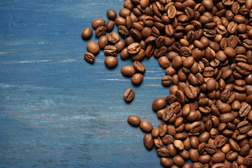 Pile of coffee beans on blue wood