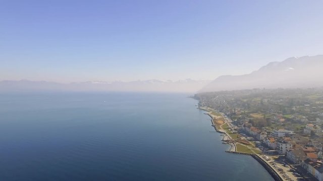 Stunning aerial drone shots of the french lake side town of Evian Les Bains. Situated on the clear blue waters of Lake Geneva on the Swiss, French Border and surrounded by high alpine peaks.