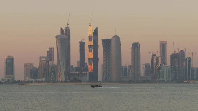 WS Financial district skyline seen across Doha Bay at sunset / Doha, Qatar