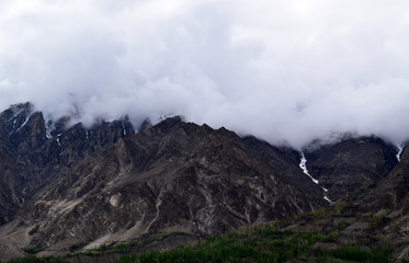 Landscape of rocky mountains with snow on peak. Mountains landscape in cloudy day. cloudy weather in the mountains.
