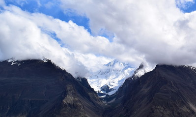 Landscape of rocky mountains with snow on peak. Mountains landscape in cloudy day. cloudy weather in the mountains.