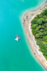 (View from above) Stunning aerial view of a a green coast of a tropical island with a traditional...