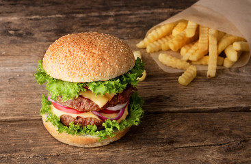hamburger with french fries on wooden background