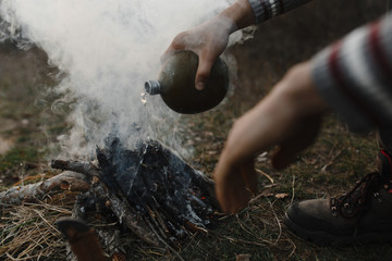 Man quenching the fireplace with water