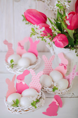 Happy easter. Decor of Easter eggs in the form of Easter bunnies in small white baskets.