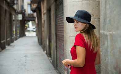 beautiful girl walks through the old European streets