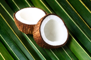 Open coconuts on lea background