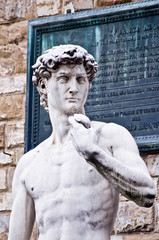statue of Michelangelo's David in Florence in front of Palazzo Vecchio