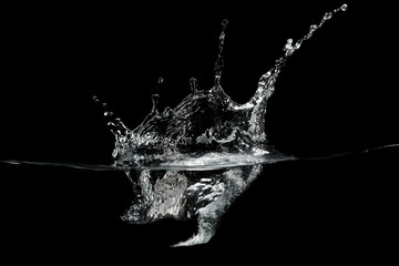 close up of water waves splash and bubbles isolated on black background.