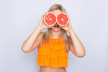 Blonde woman with grapefruit slices
