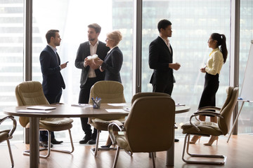 Diverse multi ethnic employees standing separately talking at work break