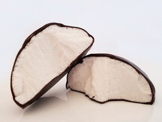 Marshmallow in chocolate broken in half on white background. Marshmallow isolated.