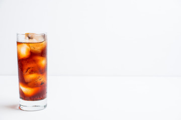 Cold cola beverage in glass with ice. Selective focus. Shallow depth of field.