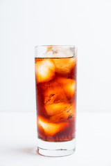 Cold cola beverage in glass with ice. Selective focus. Shallow depth of field.