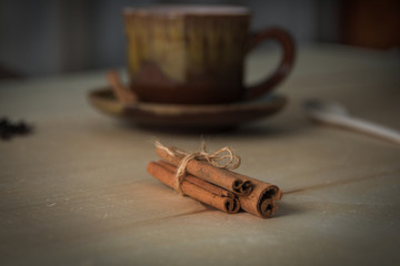 A cup of tea. Cinnamon sticks.