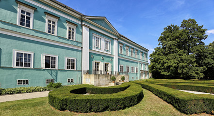 Dacice castle with green-blue facade in summer