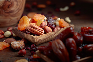 Various dried fruits and nuts in wooden dish.
