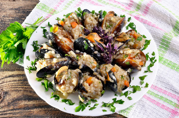 Risotto with mussels  in the plate on a wooden old table/paella/,selective focus