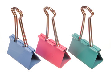Multi coloured  paper clip isolated on white background