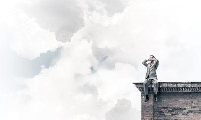 Young man on building roof dont want to hear anything