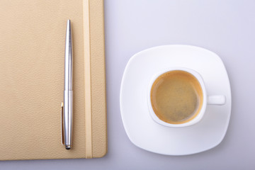 office table with notebook, computer keyboard,, cup of coffee, tablet pc. copy space.