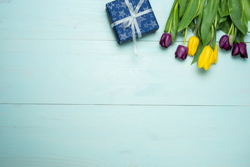 tulips on a mint wooden background