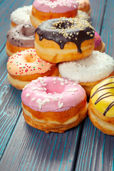 Glazed donuts on wooden background