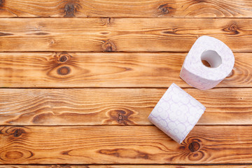 Toilet paper rolls on wooden background top view