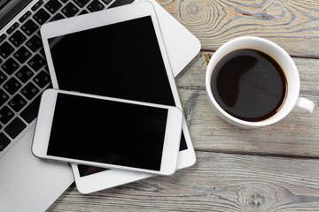 Open laptop with digital tablet and smartphone close up