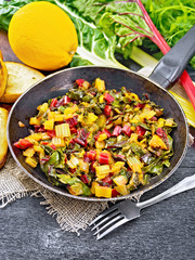 Mangold braised in pan on wooden board