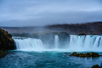 Waterfall at dusk in Iceland with soft and smooth flowing water
