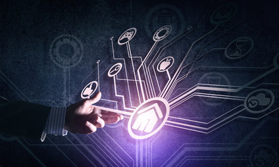 Close of businessman hand showing at user interface glowing on wall