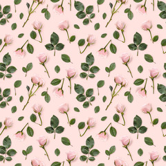 Flower pattern made from pink roses, green leaves on a pastel pink background. Flower pattern. Flower texture. Flat lay. Floral background. Top view.