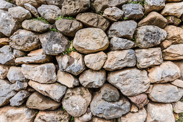 beautiful background of large stones overgrown with grass