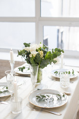 Fototapeta na wymiar Beautiful festive table setting with elegant white flowers and cutlery, dinner table decoration 