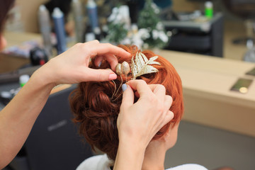 Hairdresser makes beautifull hairstyle at the salon