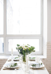 Beautiful festive table setting with elegant white flowers and cutlery, dinner table decoration 