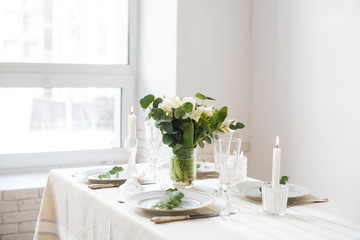 Beautiful festive table setting with elegant white flowers and cutlery, dinner table decoration 