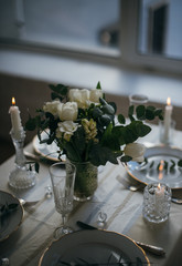 Beautiful festive table setting with elegant white flowers and cutlery, dinner table decoration 