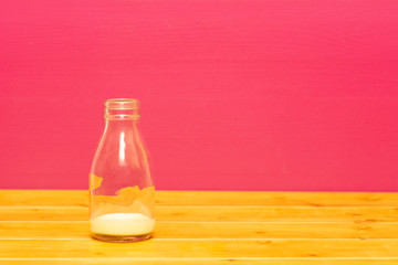 One-third pint glass milk bottle with dregs of banana milkshake