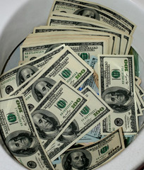 A lot of dollars in a toilet bowl. Money toilet