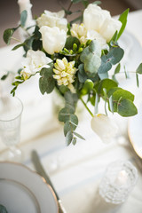 Beautiful festive table setting with elegant white flowers and cutlery, dinner table decoration 